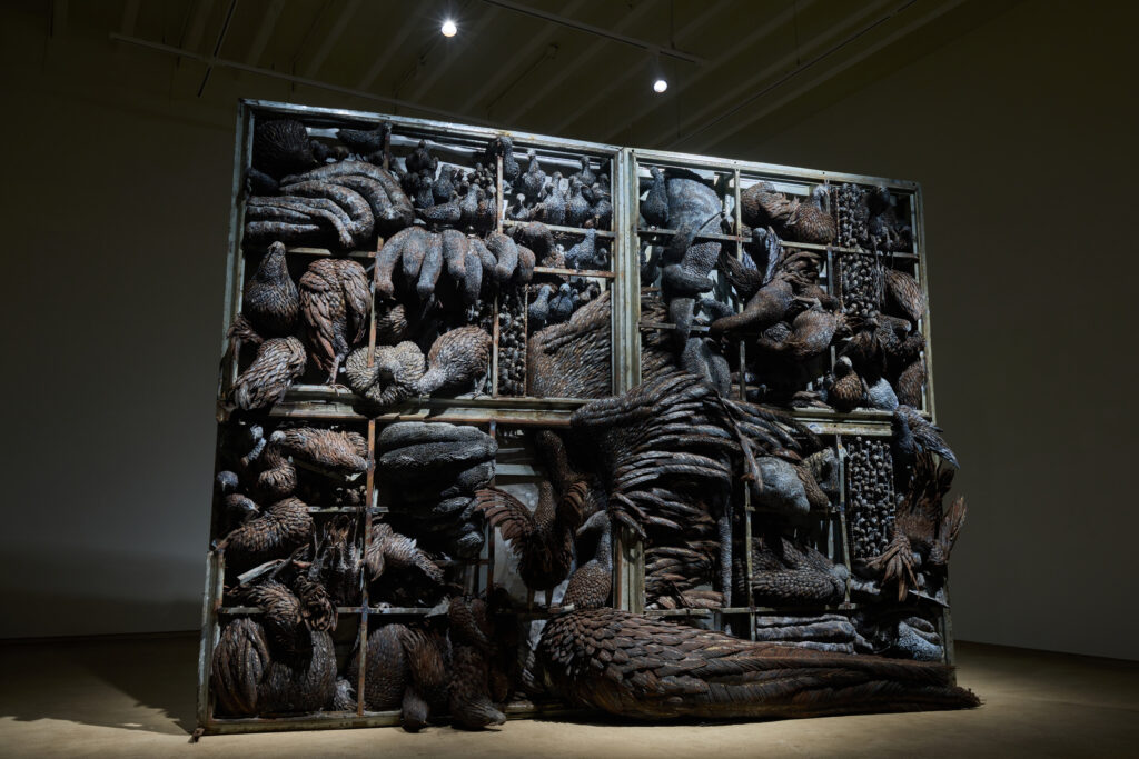 Large metal cage filled with sculpted birds.